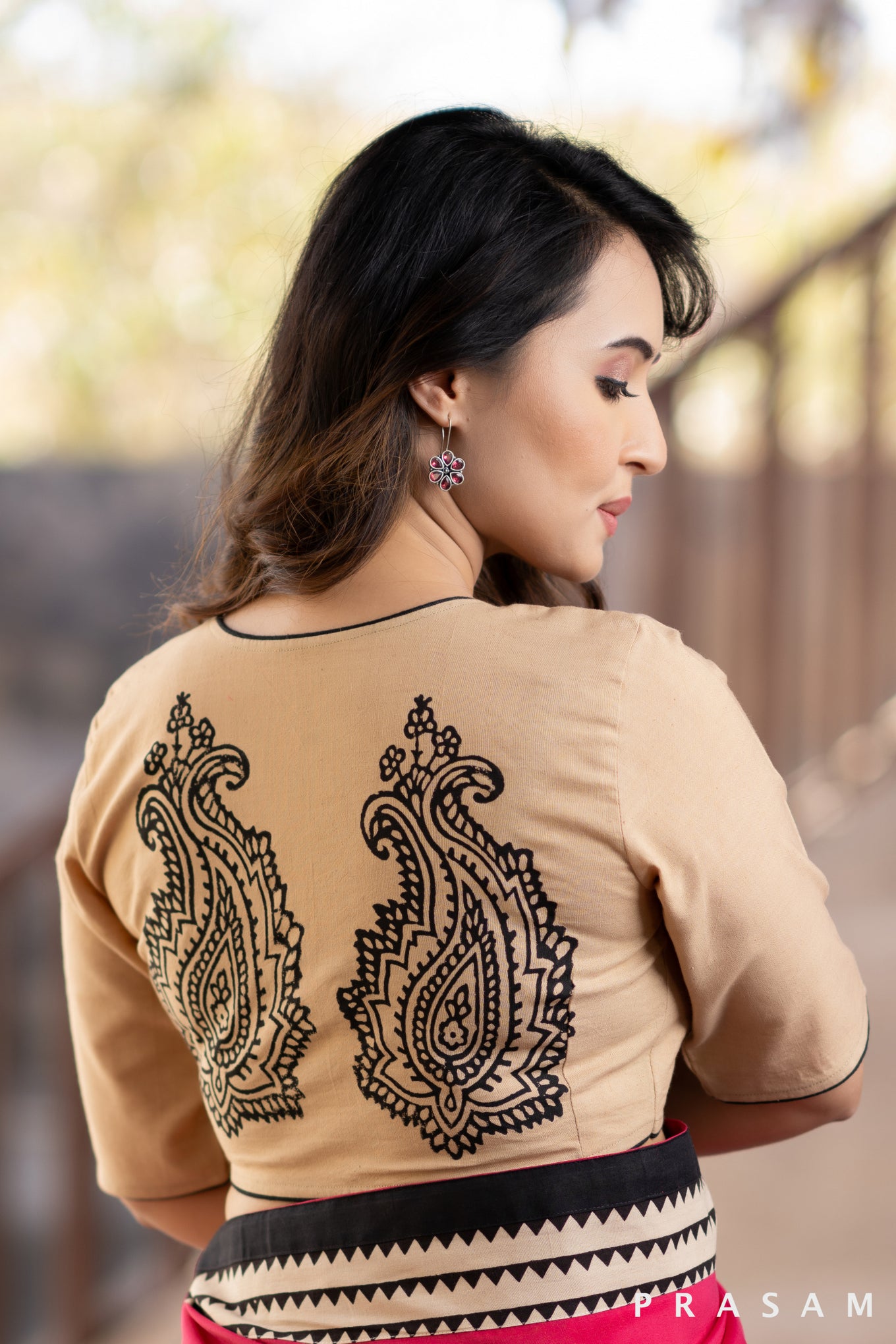 Beige cotton blouse with black trims and block print at the back