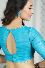 Turquoise Designer Tussar Giccha Handwoven Boat Neck Blouse with beautiful detailing in neck and borders Prasam Crafts